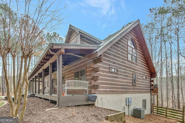 view of property exterior with cooling unit and fence