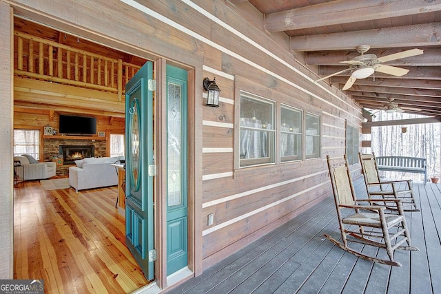 deck with a porch and ceiling fan