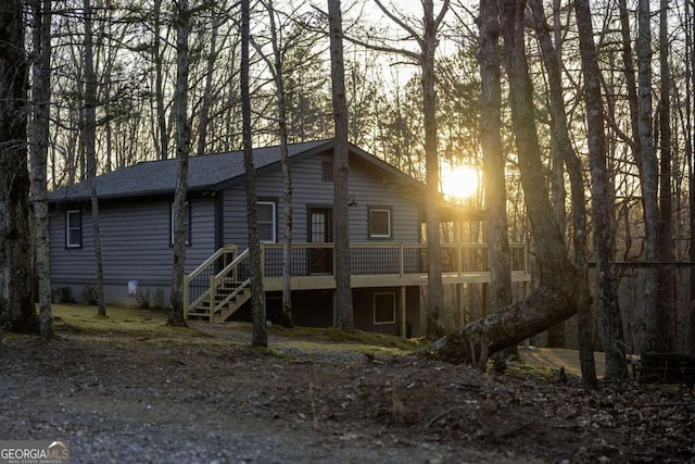 view of front of home with stairway and a deck