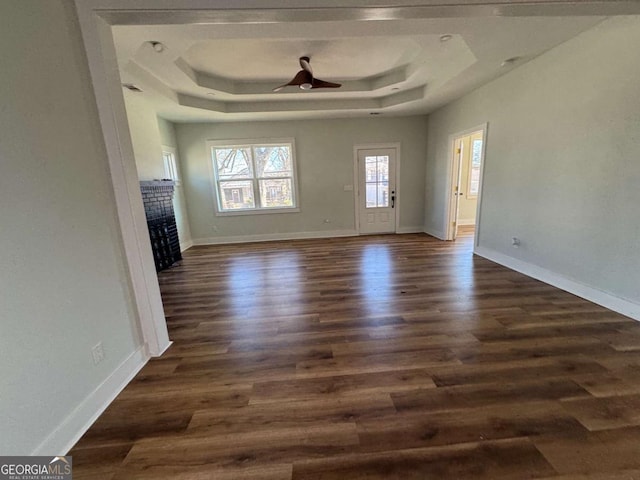 1510 Olympian Way SW, Atlanta, GA 30310 - unfurnished living room featuring a raised ceiling, dark wood-style floors, a fireplace, and a ceiling fan