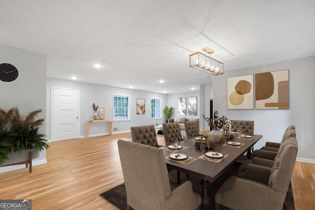 dining room with recessed lighting, baseboards, and light wood finished floors