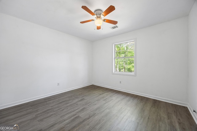 unfurnished room featuring ceiling fan, baseboards, dark wood-type flooring, and visible vents