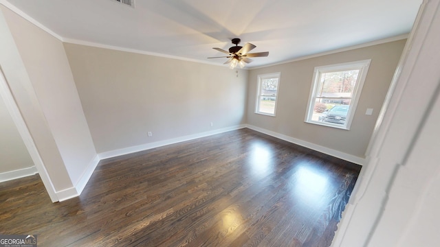 empty room featuring dark wood finished floors, baseboards, ceiling fan, and crown molding