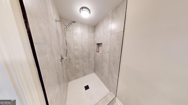 bathroom with a tile shower