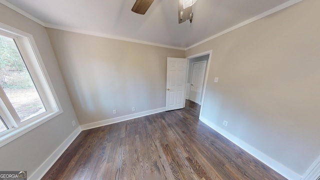 unfurnished room with ornamental molding, baseboards, a ceiling fan, and dark wood-style flooring