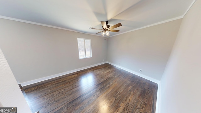 empty room with baseboards, dark wood-style flooring, ornamental molding, and a ceiling fan