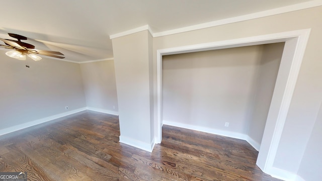 unfurnished room with baseboards, dark wood-type flooring, ornamental molding, and a ceiling fan