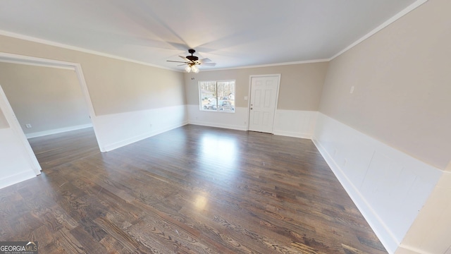 unfurnished room featuring crown molding, a ceiling fan, dark wood-style flooring, and baseboards