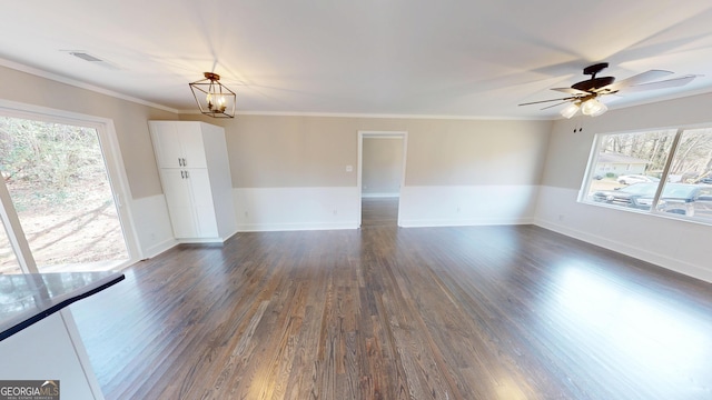 unfurnished living room featuring a wainscoted wall, visible vents, dark wood finished floors, ceiling fan, and ornamental molding