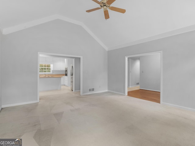 1300 Lakehaven Pkwy, Mcdonough, GA 30253 - unfurnished living room with ceiling fan, light carpet, and vaulted ceiling