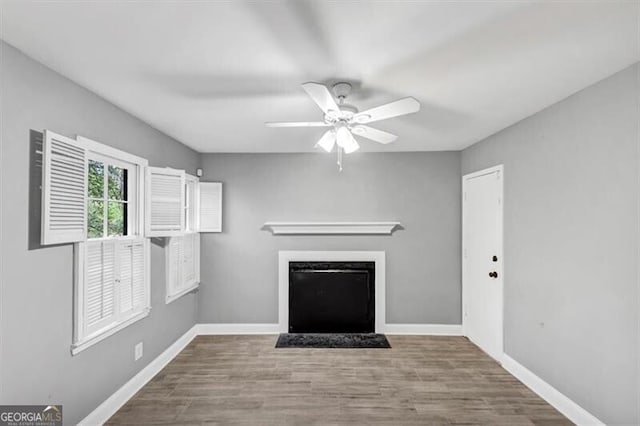 117 Lablanc Way NW, Atlanta, GA 30327 - unfurnished living room featuring a ceiling fan, wood finished floors, a fireplace, and baseboards