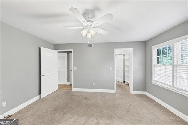 117 Lablanc Way NW, Atlanta, GA 30327 - unfurnished bedroom with visible vents, a walk in closet, carpet, baseboards, and ceiling fan