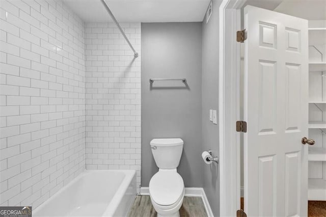 117 Lablanc Way NW, Atlanta, GA 30327 - bathroom featuring wood finished floors, washtub / shower combination, visible vents, baseboards, and toilet