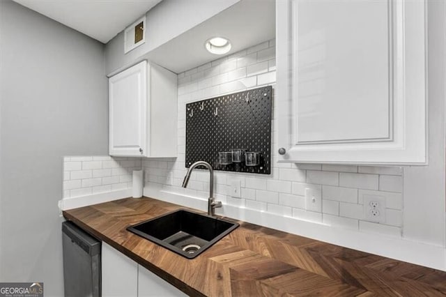 117 Lablanc Way NW, Atlanta, GA 30327 - kitchen featuring visible vents, a sink, wood counters, backsplash, and dishwashing machine