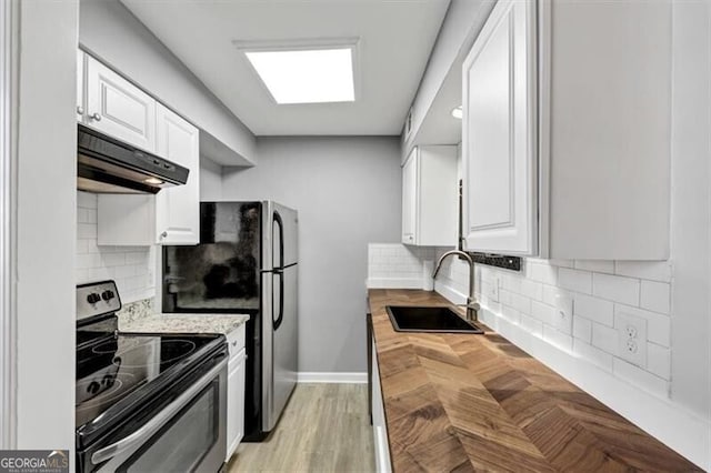 117 Lablanc Way NW, Atlanta, GA 30327 - kitchen featuring tasteful backsplash, under cabinet range hood, white cabinets, stainless steel appliances, and a sink