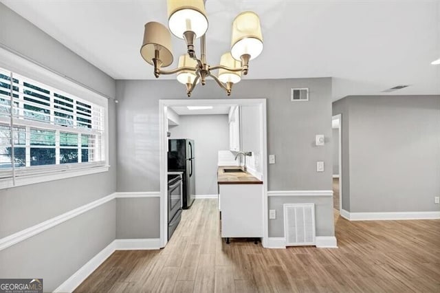 117 Lablanc Way NW, Atlanta, GA 30327 - kitchen with light wood-style floors, visible vents, and a chandelier
