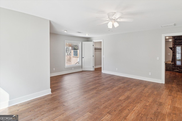unfurnished room with a ceiling fan, baseboards, and wood finished floors