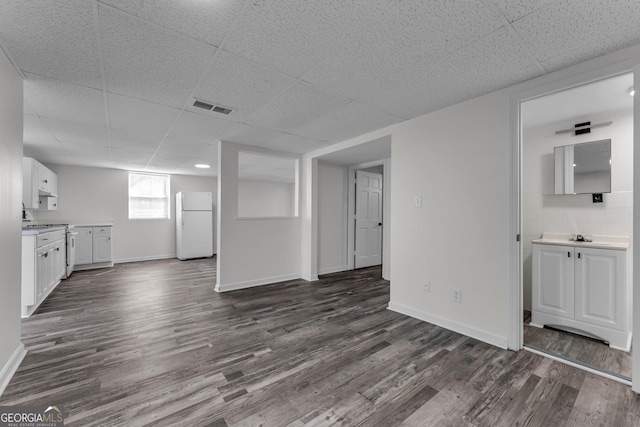 4304 Ruth Ln, Powder Springs, GA 30127 - unfurnished living room with a drop ceiling, dark wood finished floors, baseboards, and visible vents