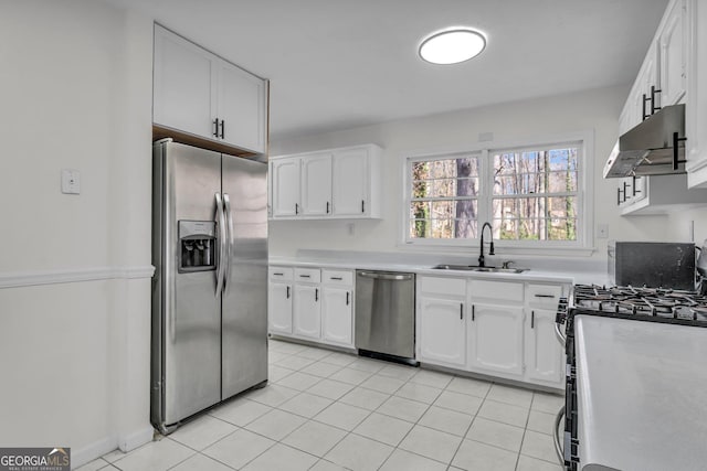 4304 Ruth Ln, Powder Springs, GA 30127 - kitchen with under cabinet range hood, white cabinets, a sink, and appliances with stainless steel finishes