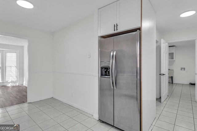4304 Ruth Ln, Powder Springs, GA 30127 - kitchen with white cabinetry, light tile patterned floors, and stainless steel fridge