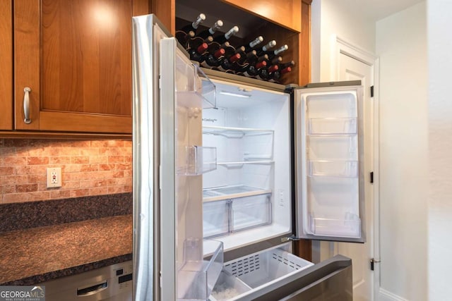 interior space with tasteful backsplash, brown cabinetry, and refrigerator with glass door