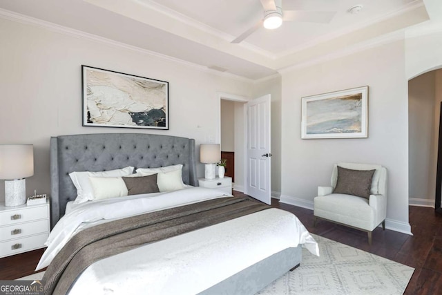 bedroom featuring arched walkways, wood finished floors, baseboards, and ornamental molding