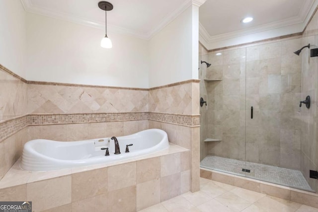 bathroom featuring a stall shower, a garden tub, and ornamental molding