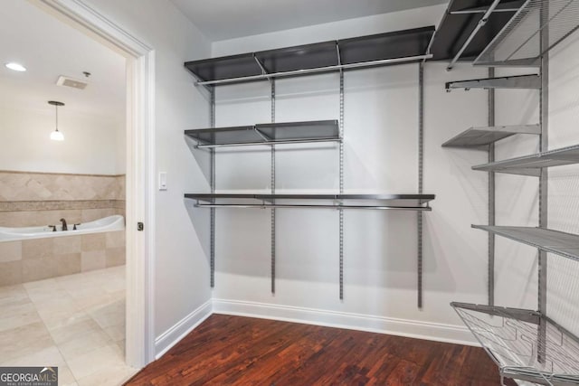 spacious closet with wood finished floors