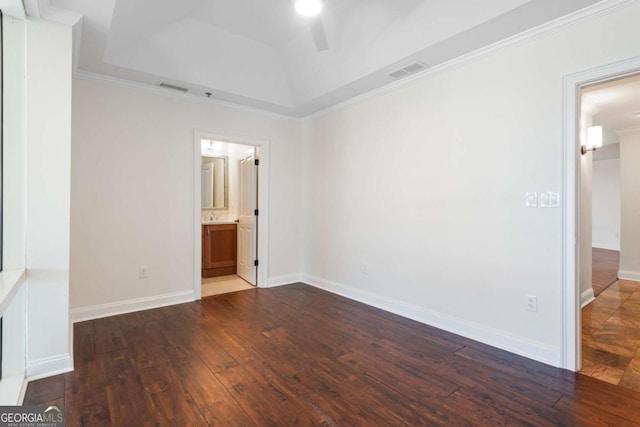 unfurnished room featuring visible vents, a raised ceiling, baseboards, and wood-type flooring