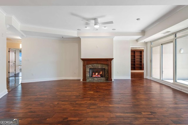 unfurnished living room featuring wood finished floors, crown molding, a ceiling fan, and baseboards