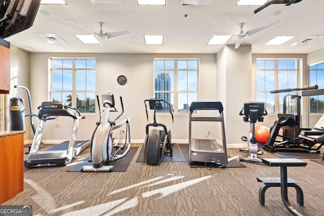 gym with plenty of natural light, baseboards, and ceiling fan