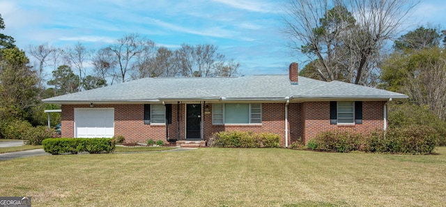 ranch-style house featuring driveway, a front yard, a garage, brick siding, and a chimney