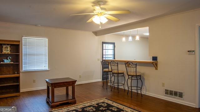 interior space with baseboards, dark wood-style floors, visible vents, and ceiling fan