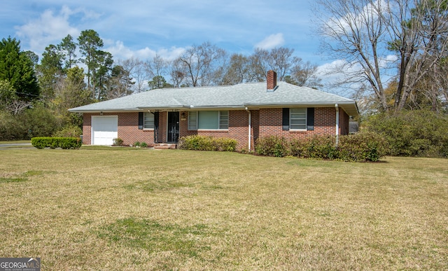 single story home featuring brick siding, an attached garage, a chimney, and a front yard