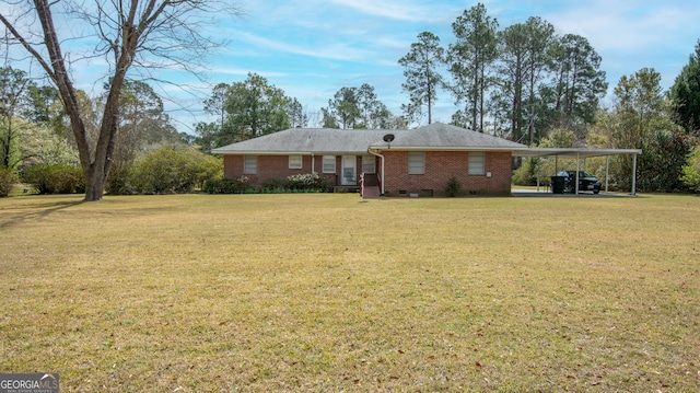 ranch-style home featuring a carport, brick siding, and a front yard