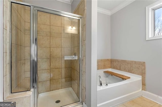 full bathroom featuring baseboards, tile patterned flooring, a shower stall, a garden tub, and ornamental molding