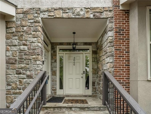 doorway to property featuring stone siding
