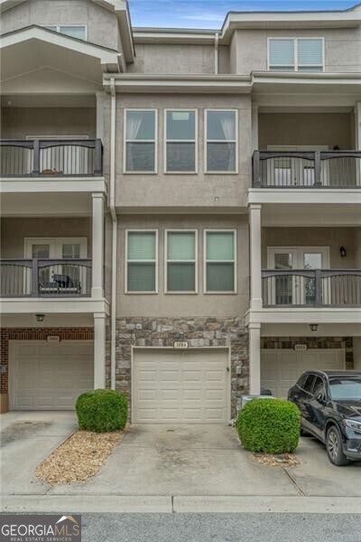 view of building exterior with an attached garage and driveway