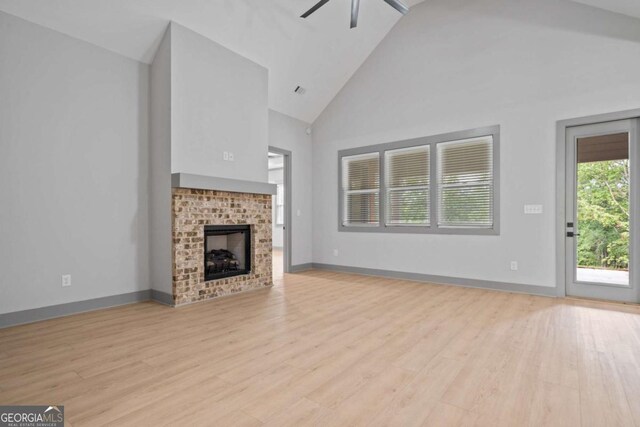 303 Tumbling Shoals Ct, Gray, GA 31032 - unfurnished living room with a fireplace, high vaulted ceiling, ceiling fan, and wood finished floors