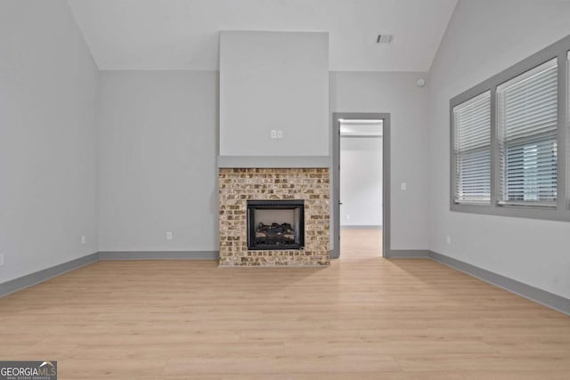 303 Tumbling Shoals Ct, Gray, GA 31032 - unfurnished living room featuring visible vents, lofted ceiling, baseboards, and light wood-style flooring