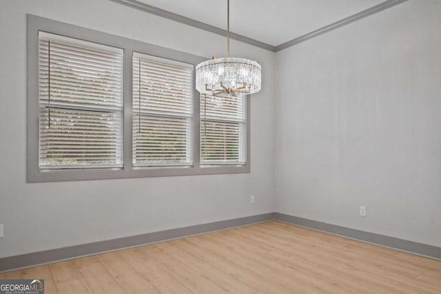 303 Tumbling Shoals Ct, Gray, GA 31032 - spare room with an inviting chandelier, wood finished floors, baseboards, and ornamental molding
