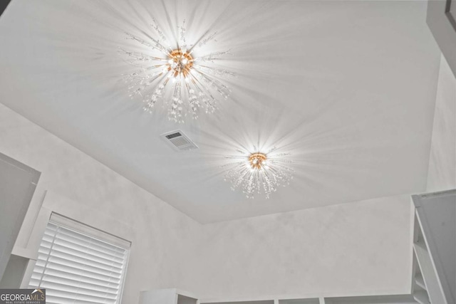 303 Tumbling Shoals Ct, Gray, GA 31032 - room details with a notable chandelier and visible vents