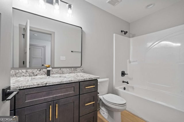 303 Tumbling Shoals Ct, Gray, GA 31032 - full bath featuring visible vents, toilet, wood finished floors, washtub / shower combination, and vanity