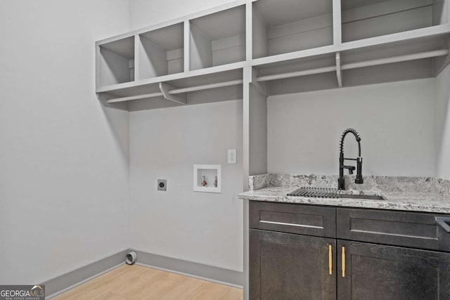 303 Tumbling Shoals Ct, Gray, GA 31032 - washroom with hookup for a washing machine, cabinet space, electric dryer hookup, a sink, and light wood-type flooring