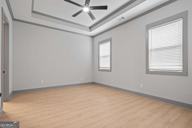 303 Tumbling Shoals Ct, Gray, GA 31032 - spare room with a tray ceiling, ornamental molding, visible vents, and ceiling fan