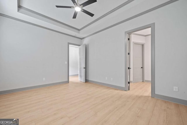 303 Tumbling Shoals Ct, Gray, GA 31032 - empty room featuring baseboards, ornamental molding, ceiling fan, a raised ceiling, and light wood-type flooring