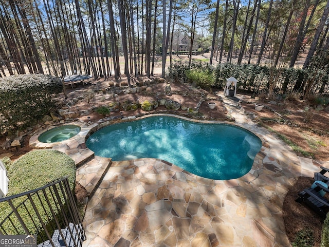 view of swimming pool with a pool with connected hot tub