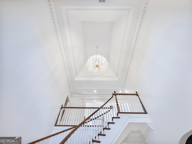 stairs featuring a high ceiling, a chandelier, and visible vents