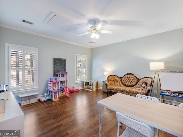 bedroom featuring attic access, visible vents, wood finished floors, and ornamental molding