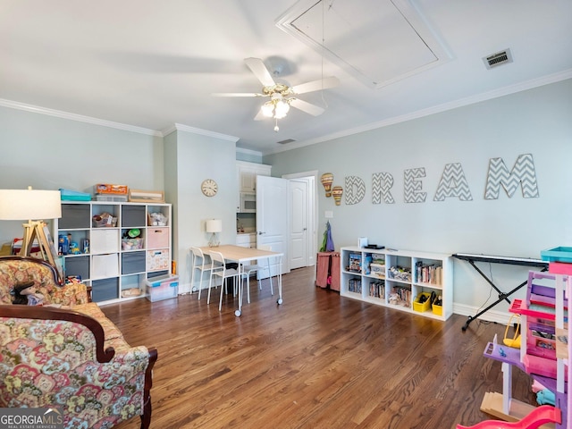 recreation room featuring visible vents, a ceiling fan, wood finished floors, and attic access